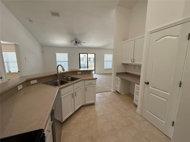 kitchen with white cabinets, ceiling fan, a sink, light tile patterned floors, and stainless steel dishwasher
