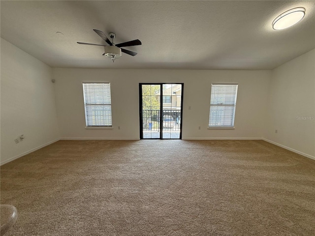 empty room with baseboards, carpet, and a ceiling fan