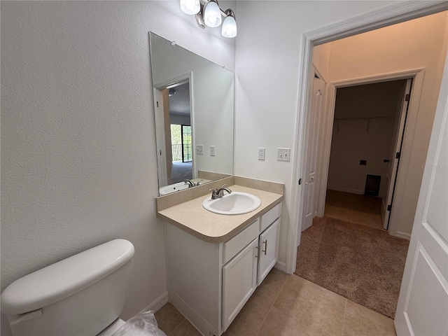 bathroom featuring vanity, tile patterned floors, and toilet
