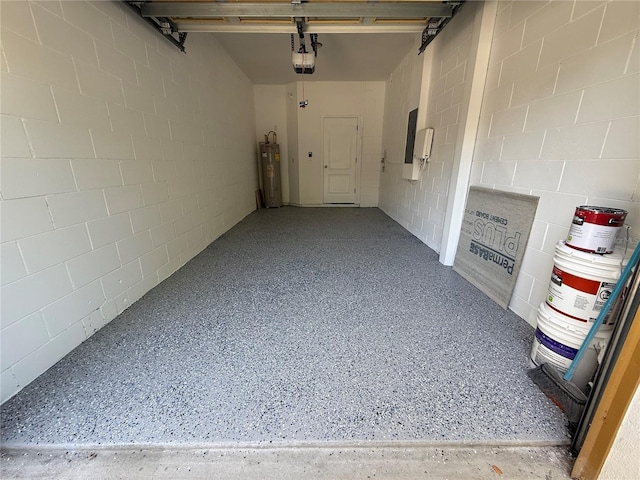 hall featuring concrete block wall, speckled floor, and electric water heater