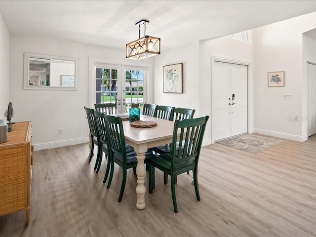 1109 SW 44th St, Cape Coral, FL 33914 - dining area with french doors, light wood-type flooring, and baseboards