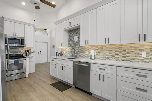1109 SW 44th St, Cape Coral, FL 33914 - kitchen with appliances with stainless steel finishes, light countertops, tasteful backsplash, ceiling fan, and a sink