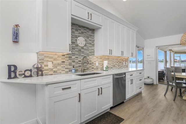 1109 SW 44th St, Cape Coral, FL 33914 - kitchen featuring stainless steel dishwasher, a sink, light countertops, backsplash, and white cabinetry