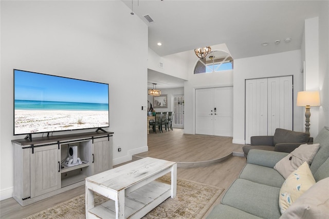 1109 SW 44th St, Cape Coral, FL 33914 - living area with a chandelier, light wood-style floors, a high ceiling, baseboards, and recessed lighting