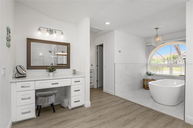 1109 SW 44th St, Cape Coral, FL 33914 - bathroom featuring a shower, wood finished floors, a soaking tub, a chandelier, and recessed lighting