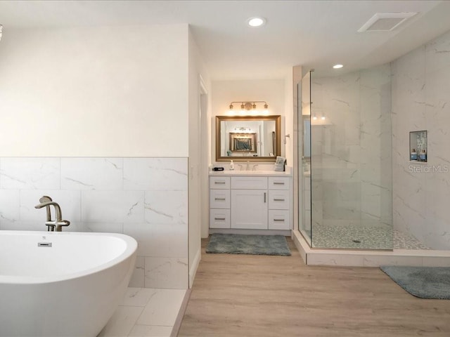 1109 SW 44th St, Cape Coral, FL 33914 - full bathroom with a marble finish shower, vanity, recessed lighting, a freestanding bath, and wood finished floors