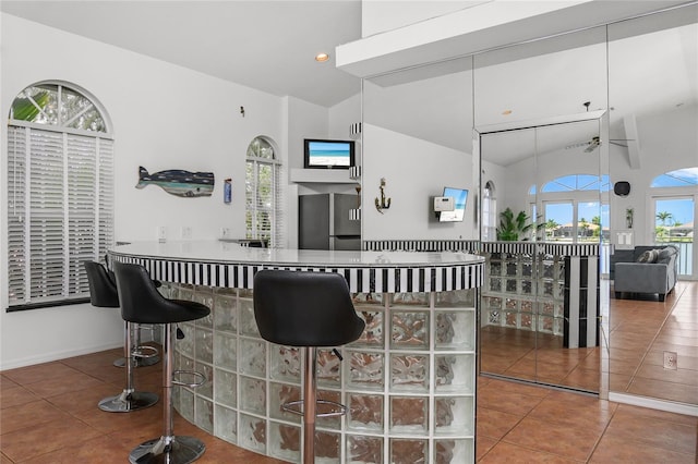 1109 SW 44th St, Cape Coral, FL 33914 - kitchen with tile patterned flooring, high vaulted ceiling, fridge, and recessed lighting