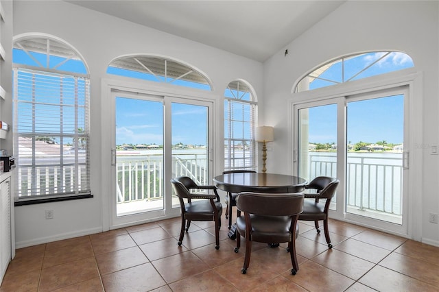 1109 SW 44th St, Cape Coral, FL 33914 - dining space featuring a water view, tile patterned flooring, baseboards, and vaulted ceiling