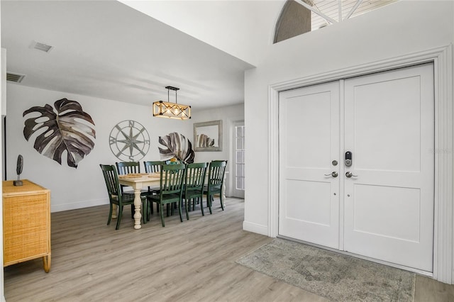 1109 SW 44th St, Cape Coral, FL 33914 - entrance foyer featuring baseboards, light wood-style flooring, and a chandelier