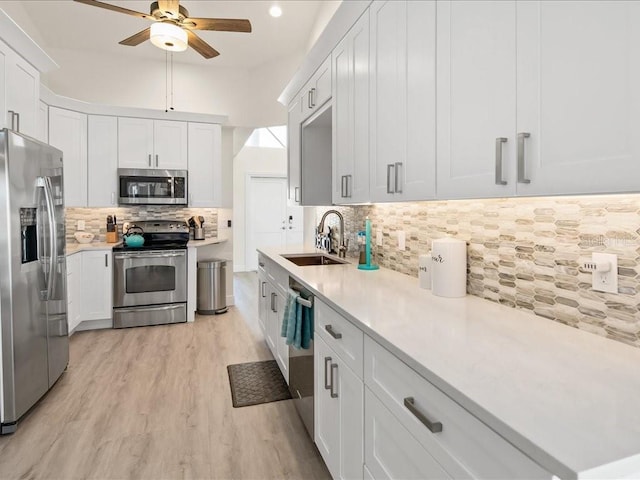 1109 SW 44th St, Cape Coral, FL 33914 - kitchen with appliances with stainless steel finishes, a sink, ceiling fan, backsplash, and light countertops