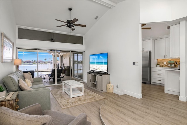 1109 SW 44th St, Cape Coral, FL 33914 - living area featuring high vaulted ceiling, a ceiling fan, light wood finished floors, and baseboards