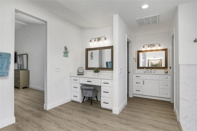 1109 SW 44th St, Cape Coral, FL 33914 - bathroom featuring wood finished floors, baseboards, and vanity