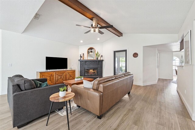 living room with ceiling fan, a fireplace, light wood-type flooring, baseboards, and recessed lighting