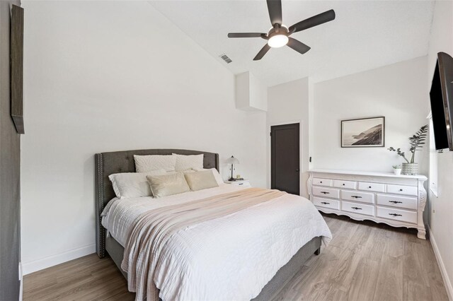 bedroom featuring a ceiling fan, baseboards, visible vents, and light wood-style floors