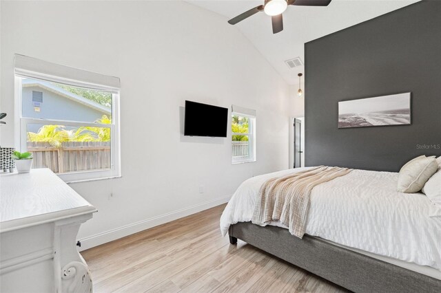 bedroom featuring light wood-style floors, high vaulted ceiling, multiple windows, and visible vents