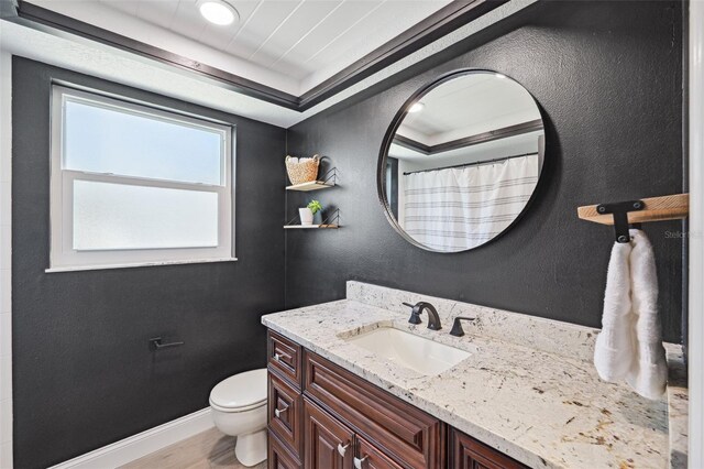 bathroom with vanity, wood finished floors, toilet, baseboards, and a shower with curtain