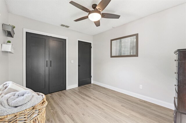 bedroom with ceiling fan, baseboards, visible vents, and light wood-style flooring