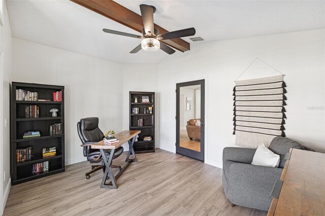 office space featuring vaulted ceiling, baseboards, a ceiling fan, and light wood finished floors
