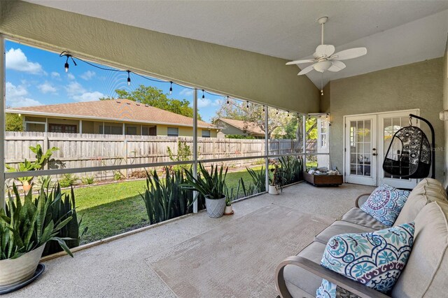 sunroom / solarium featuring a healthy amount of sunlight, a ceiling fan, and an outdoor hangout area