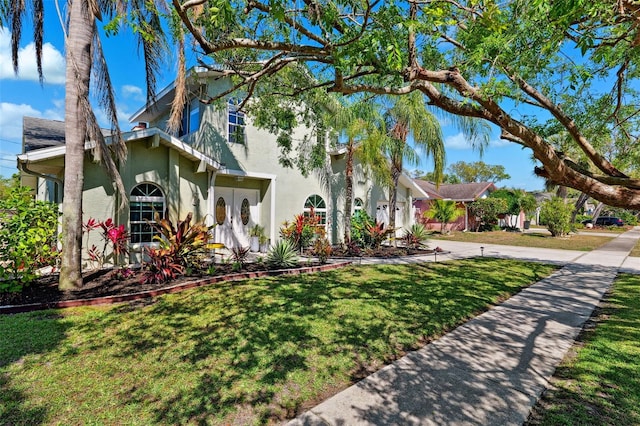 640 Kenneth Way, Tarpon Springs, FL 34689 - view of front of property featuring a front lawn, stucco siding, and driveway