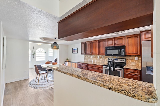 640 Kenneth Way, Tarpon Springs, FL 34689 - kitchen featuring brown cabinets, appliances with stainless steel finishes, light wood-style flooring, baseboards, and tasteful backsplash