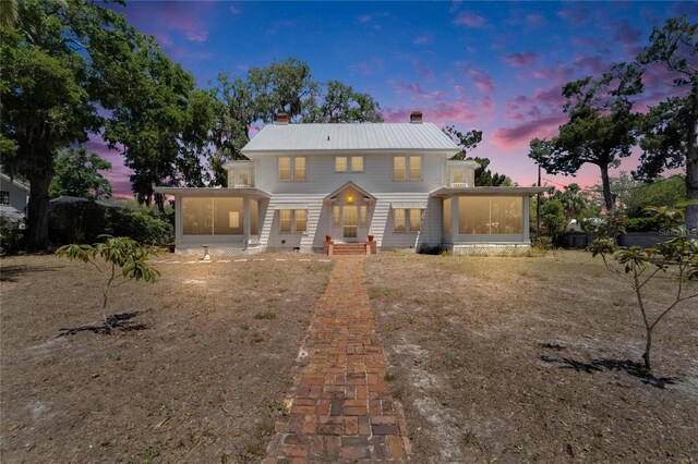 5603 Palmetto Rd, New Port Richey, FL 34652 - traditional-style house with a chimney and a sunroom