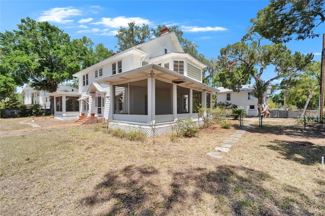 5603 Palmetto Rd, New Port Richey, FL 34652 - rear view of property featuring a sunroom, fence, a yard, and a chimney