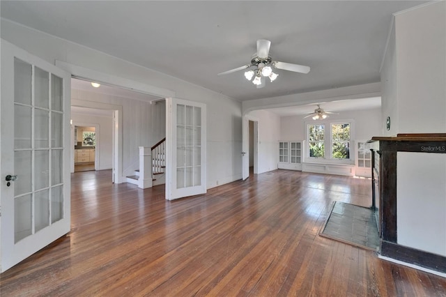 5603 Palmetto Rd, New Port Richey, FL 34652 - unfurnished living room featuring ceiling fan, french doors, a fireplace, wood finished floors, and stairs