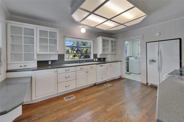 5603 Palmetto Rd, New Port Richey, FL 34652 - kitchen with visible vents, crown molding, white appliances, washer / clothes dryer, and dark wood-style floors
