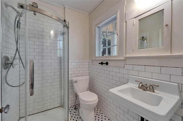 5603 Palmetto Rd, New Port Richey, FL 34652 - bathroom with crown molding, tile walls, a stall shower, a wainscoted wall, and toilet