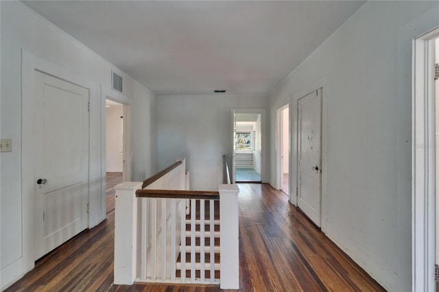 5603 Palmetto Rd, New Port Richey, FL 34652 - hallway featuring visible vents, dark wood finished floors, and an upstairs landing