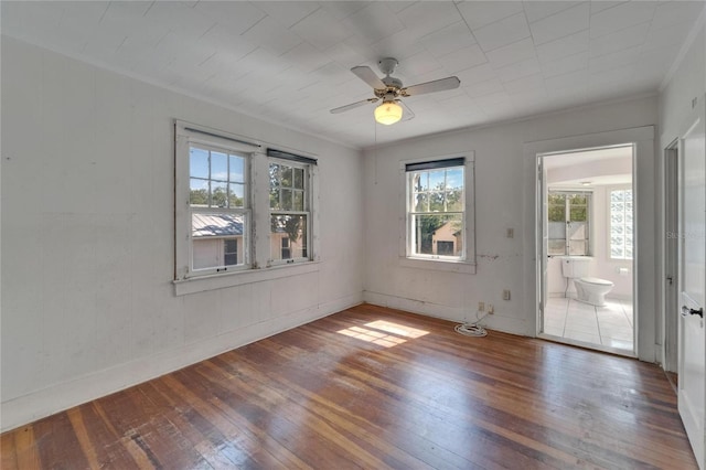 5603 Palmetto Rd, New Port Richey, FL 34652 - empty room featuring crown molding, baseboards, a ceiling fan, and hardwood / wood-style flooring