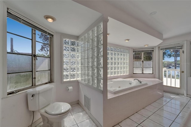 5603 Palmetto Rd, New Port Richey, FL 34652 - full bathroom featuring a garden tub, tile patterned floors, visible vents, and toilet