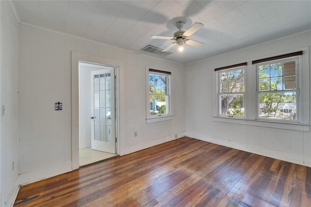 5603 Palmetto Rd, New Port Richey, FL 34652 - unfurnished room with wood walls, hardwood / wood-style floors, a ceiling fan, visible vents, and ornamental molding
