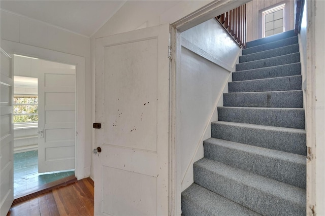 5603 Palmetto Rd, New Port Richey, FL 34652 - stairway featuring wood-type flooring and vaulted ceiling