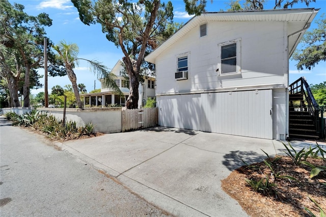 5603 Palmetto Rd, New Port Richey, FL 34652 - view of side of home featuring fence and stairs