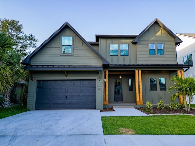 craftsman inspired home featuring a front lawn, board and batten siding, a porch, a standing seam roof, and driveway