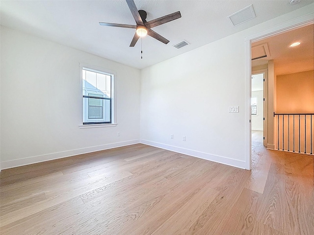 unfurnished room with visible vents, ceiling fan, and light wood-type flooring