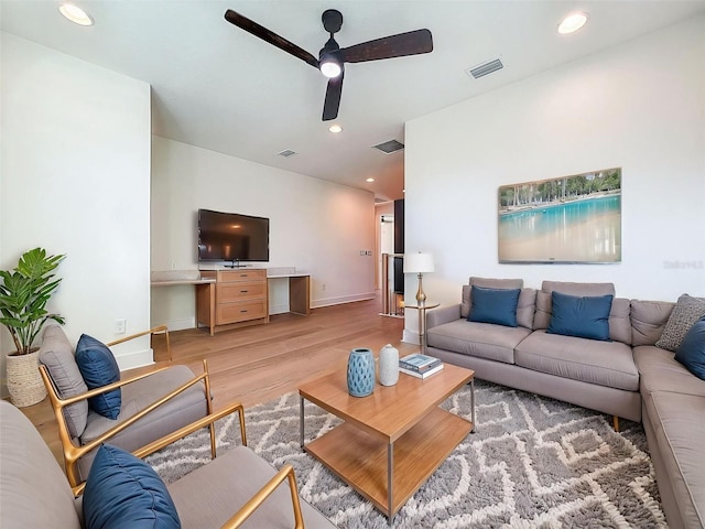 living room with a ceiling fan, recessed lighting, light wood-style flooring, and visible vents