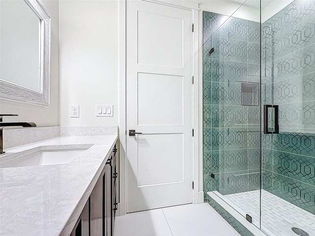full bath featuring vanity, tile patterned flooring, and a stall shower