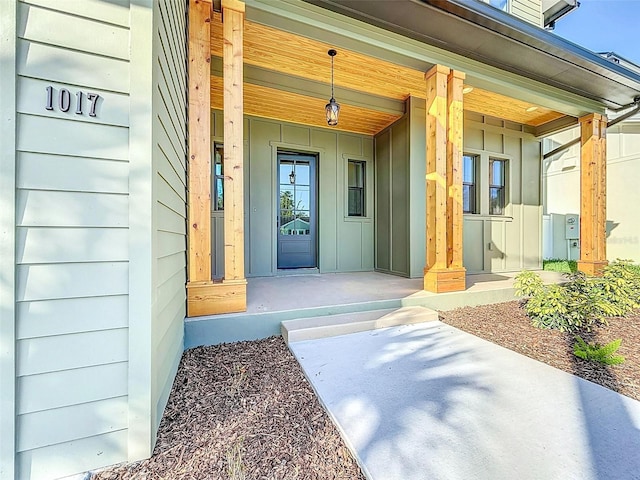 doorway to property with covered porch and board and batten siding