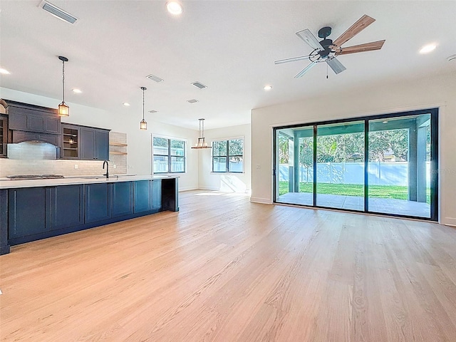 unfurnished living room featuring visible vents, recessed lighting, and light wood-style floors