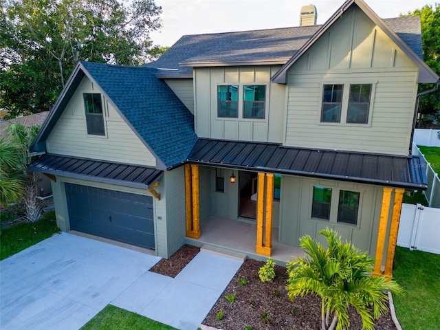 modern farmhouse featuring board and batten siding, a standing seam roof, and a porch