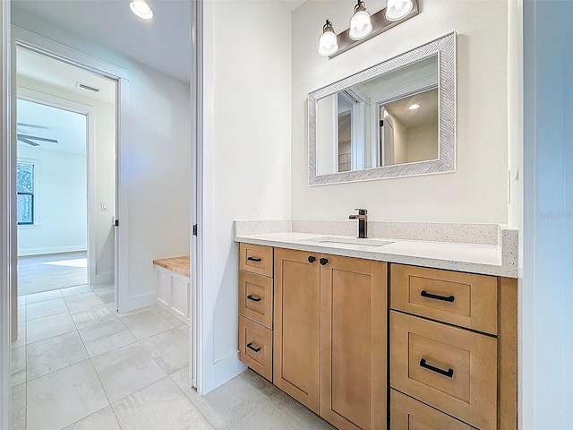 bathroom with vanity, tile patterned flooring, baseboards, and visible vents
