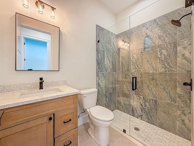 full bathroom with vanity, tile patterned flooring, a stall shower, and toilet