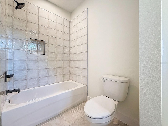 bathroom featuring baseboards, bathtub / shower combination, and toilet