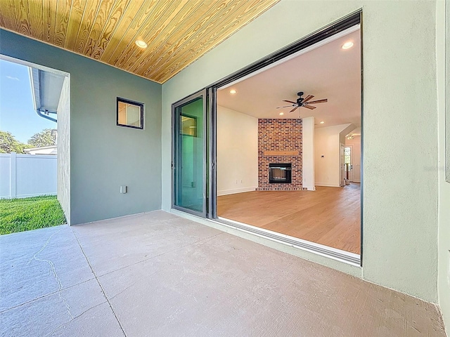view of patio / terrace with ceiling fan and fence