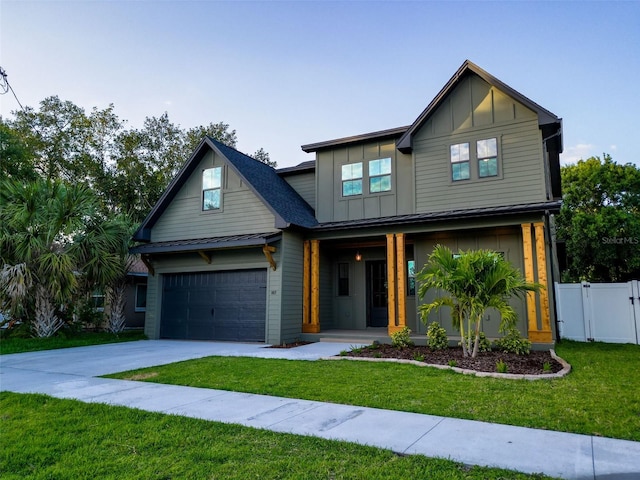 view of front of property with fence, a front yard, board and batten siding, a porch, and driveway