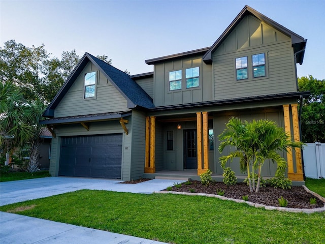 craftsman-style house featuring board and batten siding, covered porch, driveway, a front yard, and a garage