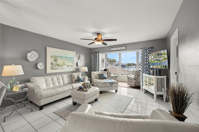 tiled living area with ceiling fan